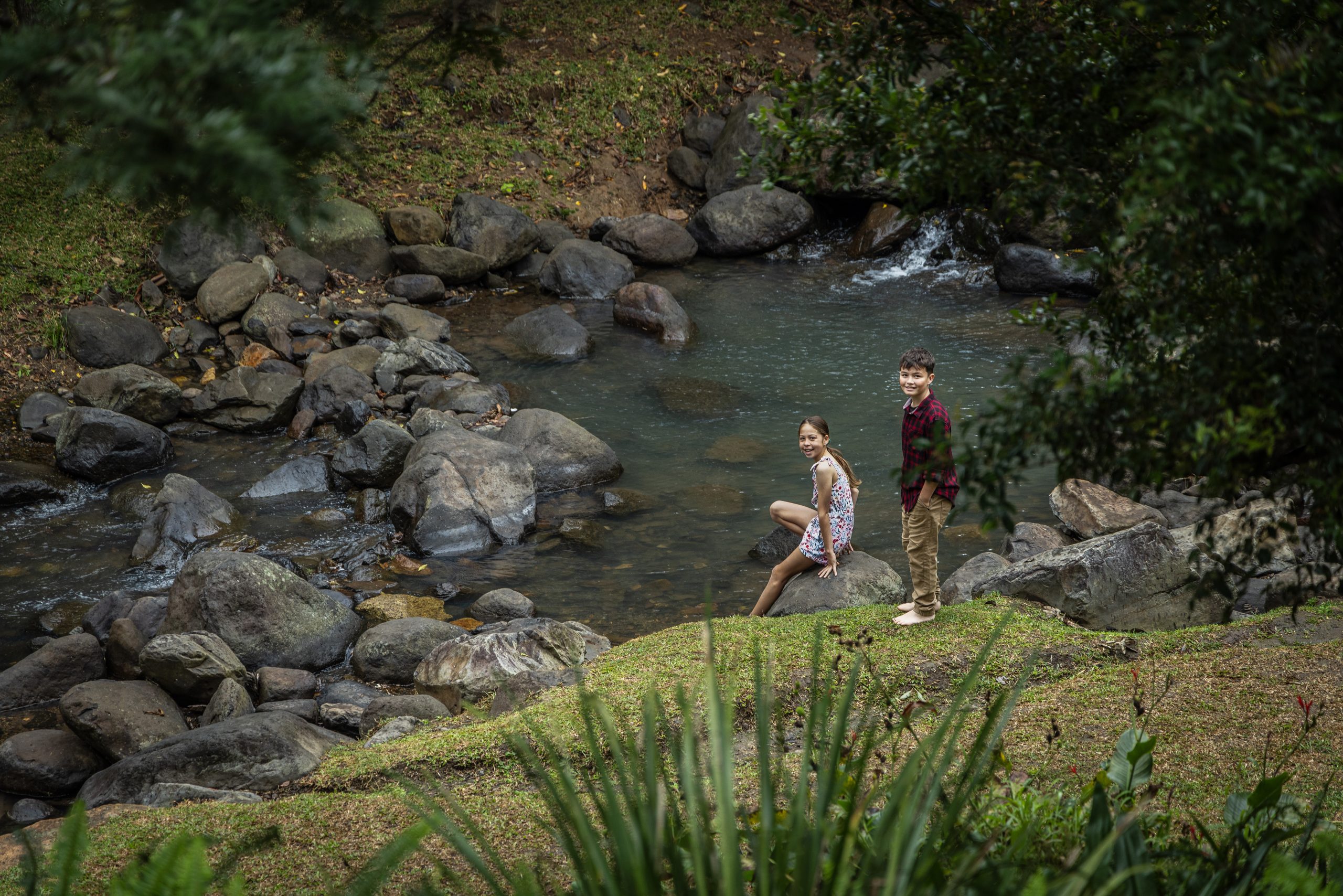 Family walking beside Cedar Creek